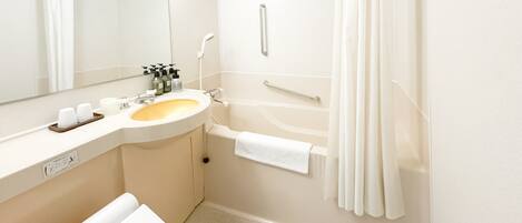 A modern bathroom with a sink, mirror, and toilet.