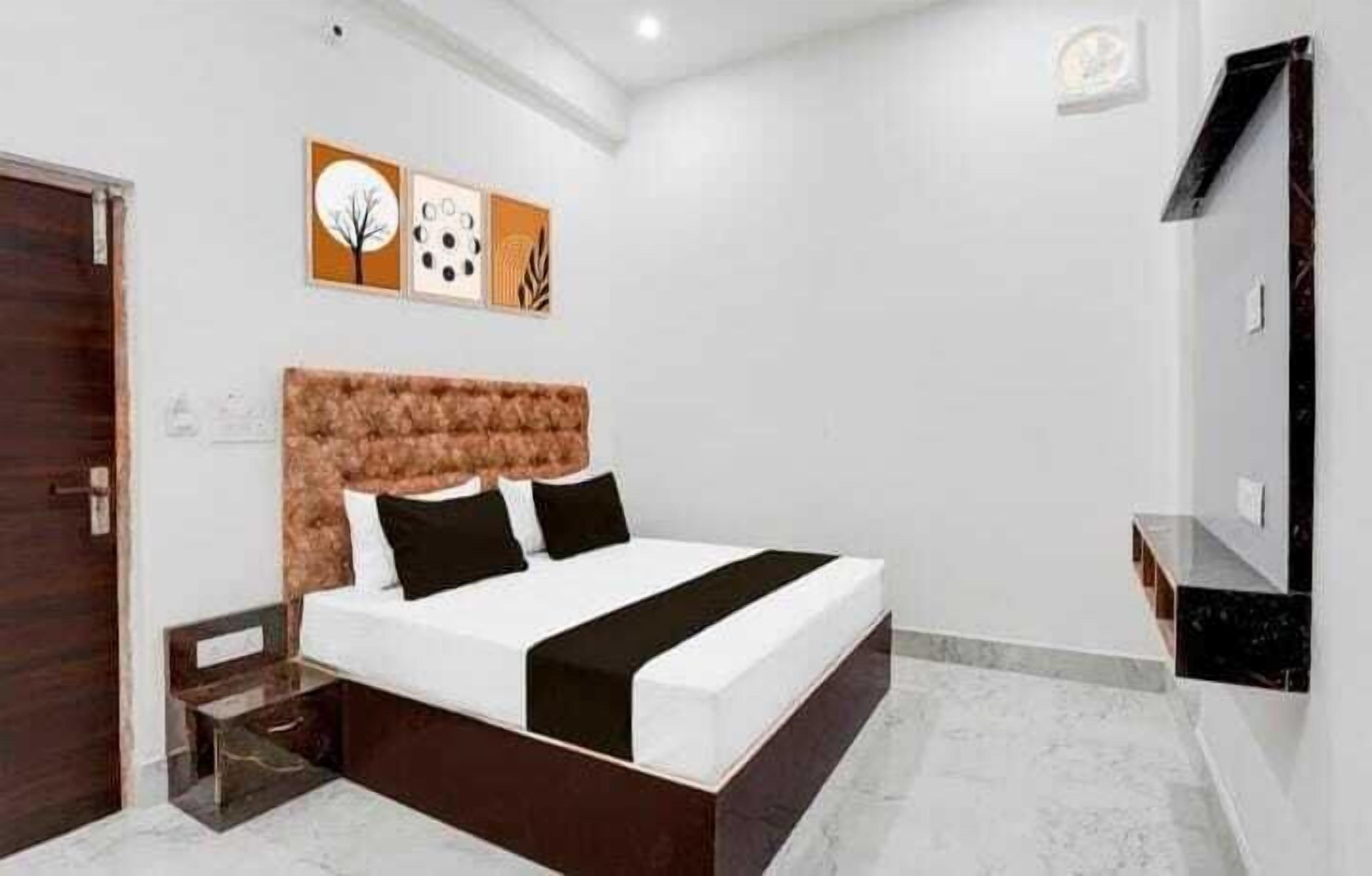 A modern bedroom with a large bed, a wooden headboard, and a marble floor.