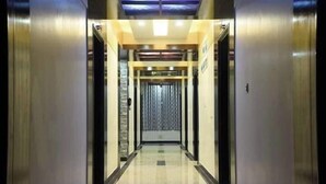 A modern elevator lobby with a reflective floor and metallic walls. - Elaf International Cox's Bazar (Cox's Bazar)