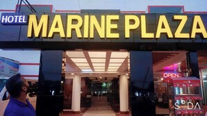 The entrance to Hotel Marine Plaza with a clear sign and a visible Q-Bistro menu board. - Hotel Marine Plaza (Cox's Bazar)
