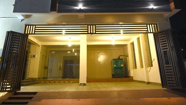 A multi-story building with a modern design, featuring balconies and a well-lit entrance. - Stanza Premium Hotels (Bhubaneshwar)