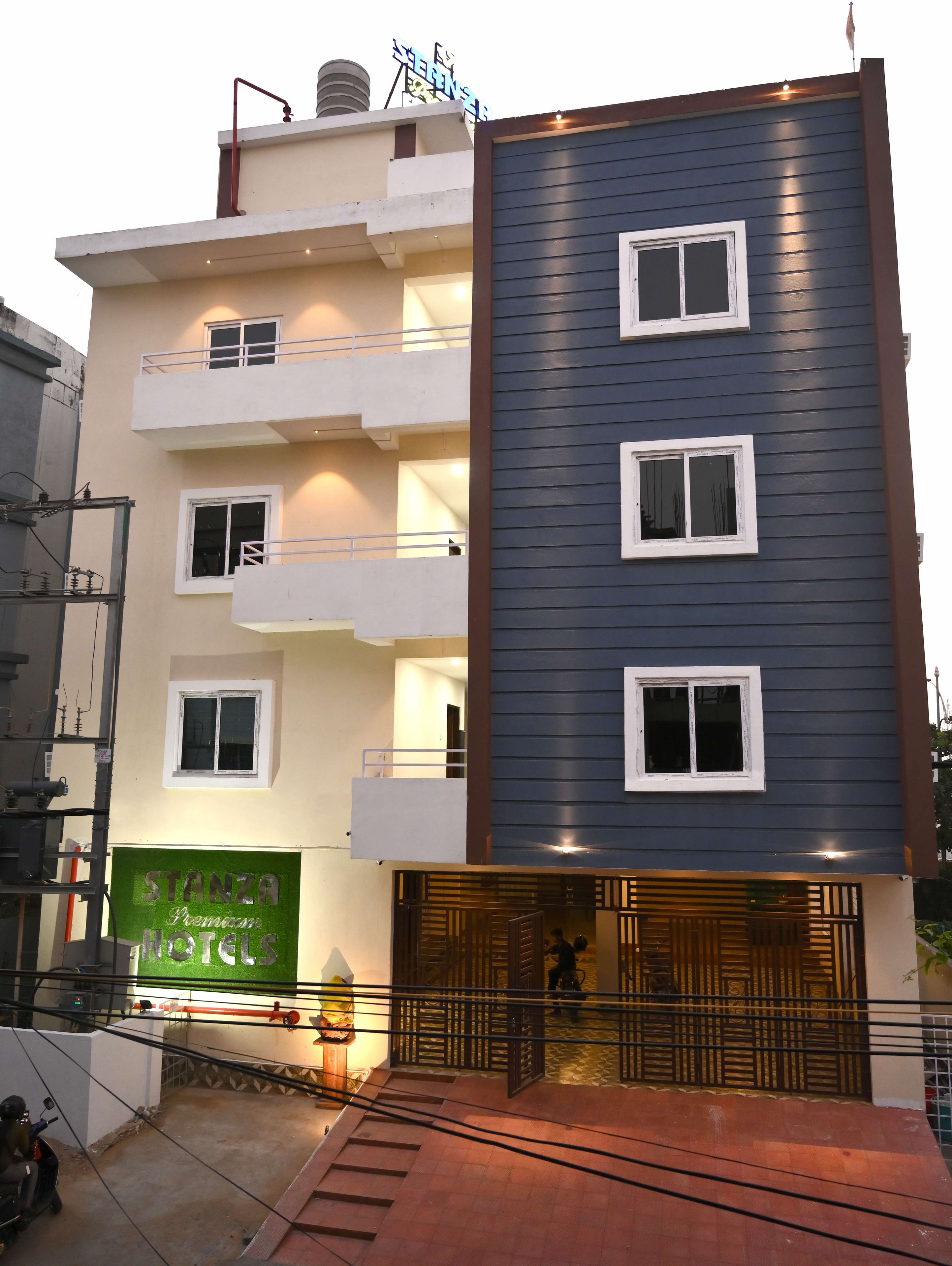 A multi-story hotel with a modern facade, balconies, and a visible entrance.
