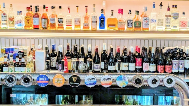 A bar with a variety of liquor bottles and a selection of beer taps. - AMBASSADORS HOTEL ADELAIDE (Adelaide)