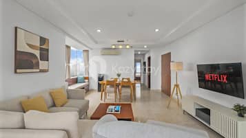 Apartment, 3 Bedrooms, City View | Living room | 50-inch Smart TV with cable channels, Netflix, streaming services