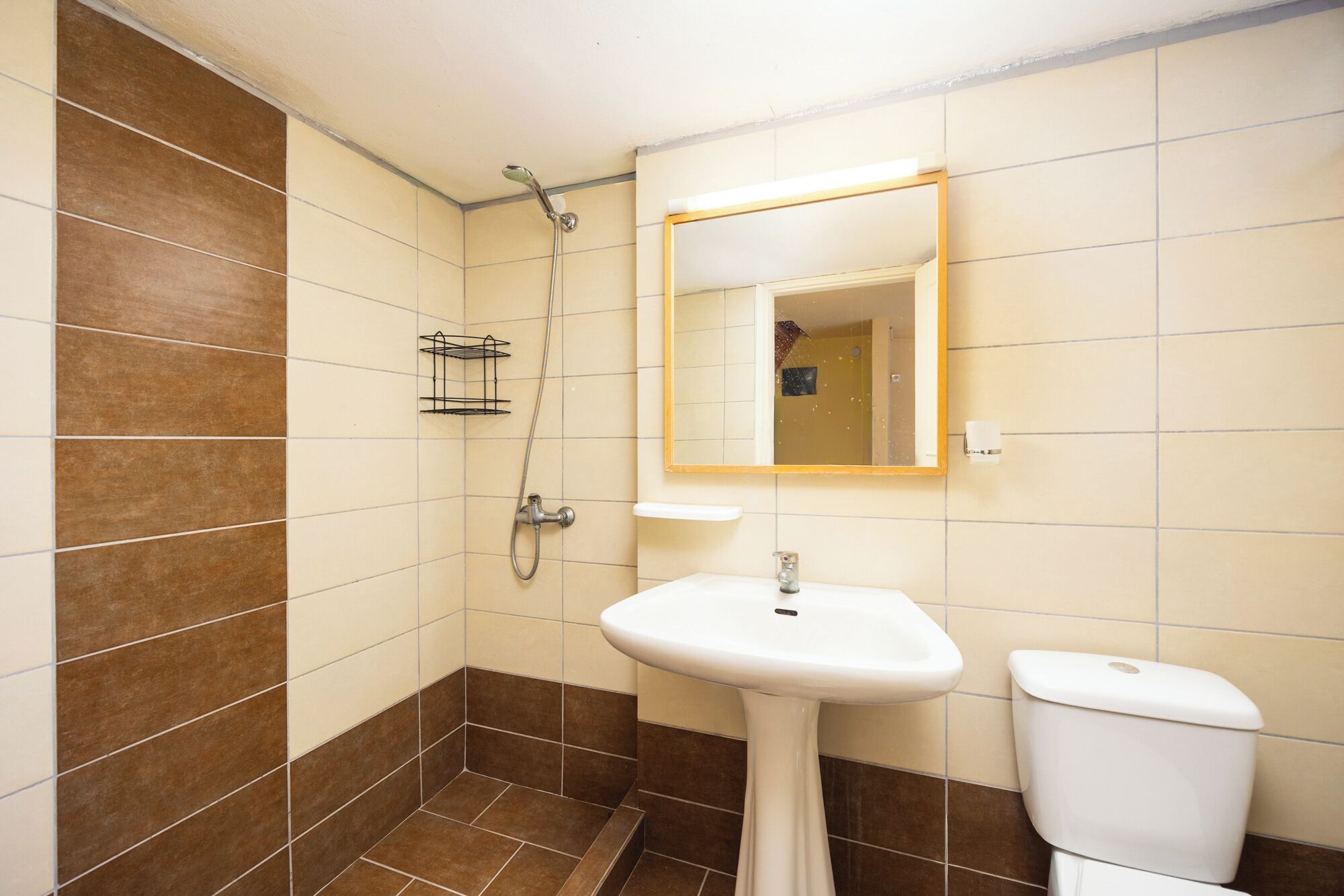 A bathroom with a shower, sink, and toilet.