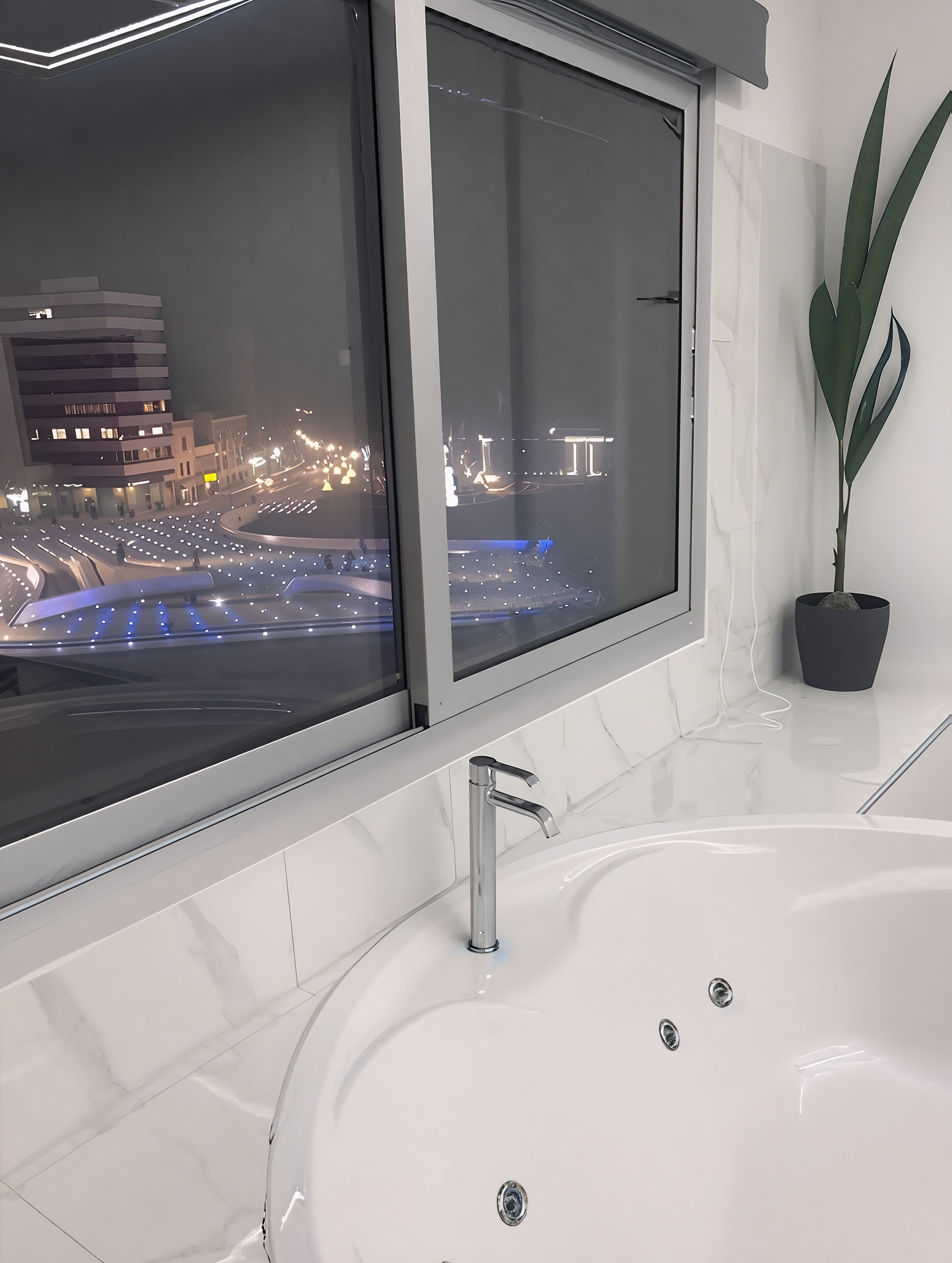 A modern bathroom with a large bathtub, a window overlooking a cityscape at night, and a potted plant.