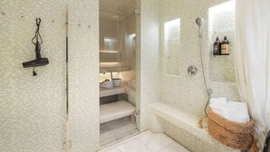 A bathroom with a shower, a sink, and a vanity. There is a towel rack and a basket on the sink. - Luxury Penthouse | Sauna | Balcony | AirCon (Helsinki)