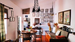 A cozy living room with a sofa, a dining table with chairs, and a kitchen in the background. - El Trazo, perfect to disconnect. (tacoronte)