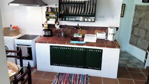 A compact kitchen with a stove, sink, and a hanging light fixture. - El Trazo, perfect to disconnect. (tacoronte)