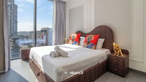 A modern hotel room with a large bed, a nightstand, and a view of the city. - Manzil - Stylish 1BR with Pool and Gym  (Dubai)