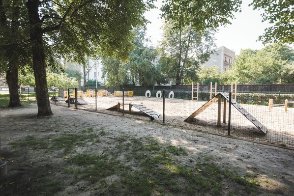 A playground with climbing structures and a fenced area.