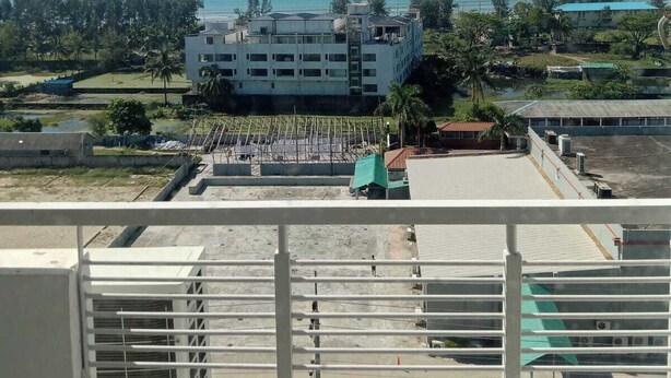 A view of a building with multiple floors and a flat roof, surrounded by greenery and a clear sky. - Hotel Beach Park (Cox's Bazar)