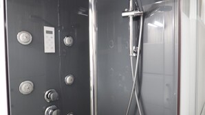 A shower with a handheld showerhead and multiple control knobs. - Cozy studio for 5 people in Samoëns (Samoëns)