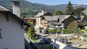 A residential area with houses, a road, and a mountain backdrop.