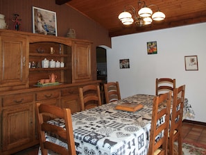 Ein Essbereich mit Holzkästen, einer gemusterten Tischdecke und einer Kronleuchter.