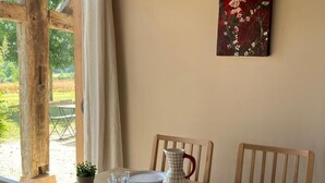 Een eettafel gedekt voor vier personen, met borden, glazen en een karaf.