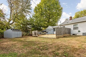 A backyard with a wooden deck, a shed, and a house. - Pet-Friendly Broad Ripple Home W/ Fenced Backyard (Indianapolis)