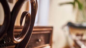 A close-up of a wooden chair with a curved backrest and a textured seat.