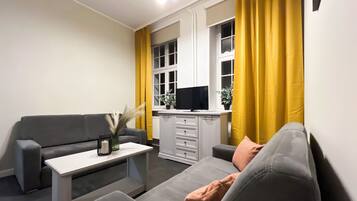 Apartment, Courtyard View | Living room | Flat-screen TV