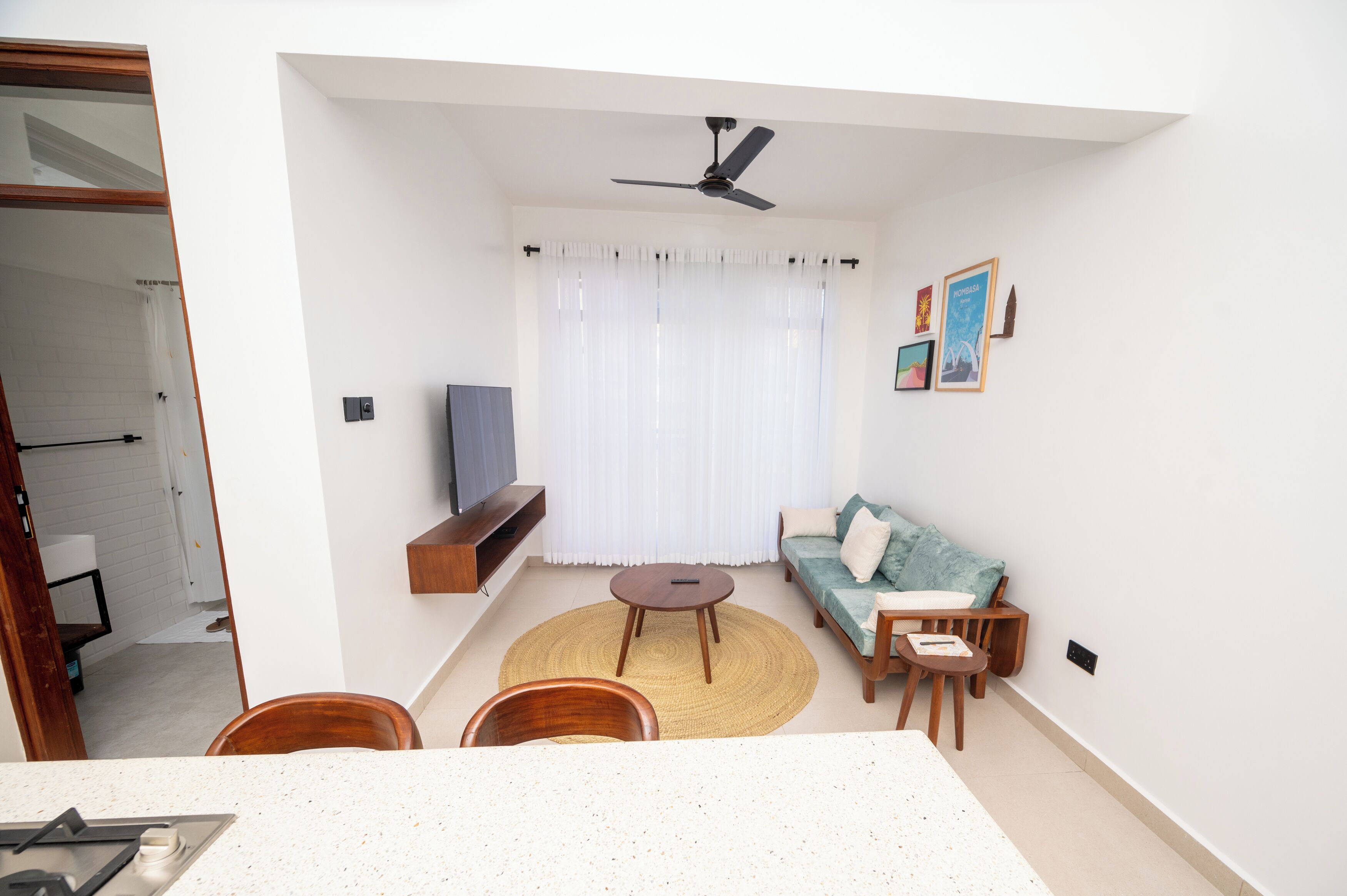 A modern living room with a sofa, a coffee table, and a TV.