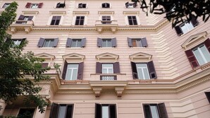 A multi-story building with a classical architectural style, featuring symmetrical windows and decorative moldings. - l'abbraccio di Maria (Naples)