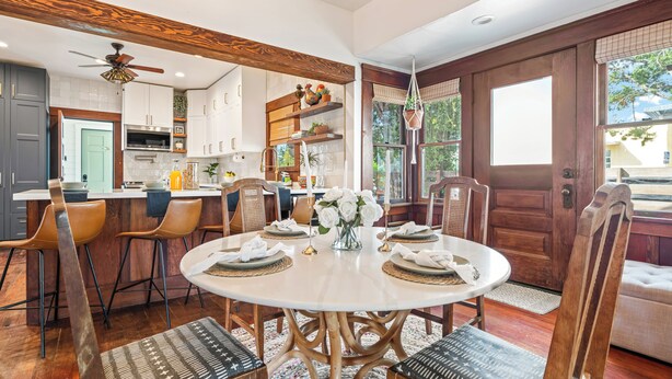A dining area with a round table, chairs, and a ceiling fan. - 2 Side-by-Side San Diego Homes w/ Shared Backyard, Firepit & BBQ (San Diego)