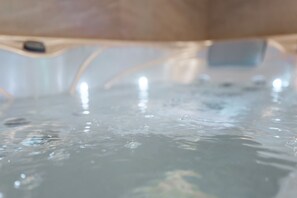 A close-up of a water feature with a reflective surface and bubbles.