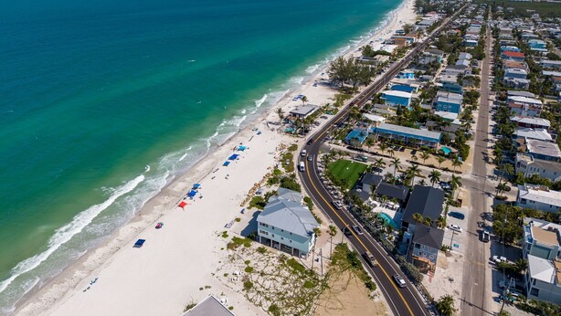 A coastal town with a beach, houses, and a road. - Endless Memories - 1801   “Anna Maria Island” (Bradenton Beach)