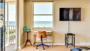 A room with a desk, chair, and a TV mounted on the wall. - Walk to Bonita Beach: Top-floor Condo w/ Views (Bonita Springs)