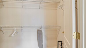 A walk-in closet with metal shelving units, a hanging rod, and a shoe rack. - Golf Getaway! Surprise Gem w/ Covered Patio (Surprise)