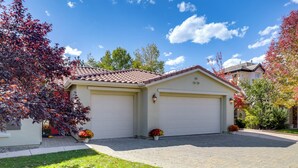 A single-story house with a garage, a paved driveway, and a well-maintained lawn. - 13 Mi to Slopes: Cozy Home w/ Fenced Yard in Reno (Reno)