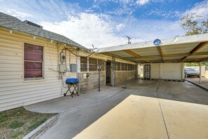 A covered parking area with a building adjacent to it. - Convenient Studio w/ Private Bar in Odessa (Odessa)