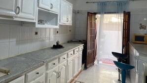 A kitchen with white cabinets, a marble countertop, and a microwave. - Beautiful house, very comfortable, fully equipped, 500m from the beach, close to everything✅ (Boumerdes)