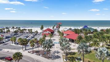 A coastal hotel with a parking lot, beach access, and a view of the ocean.