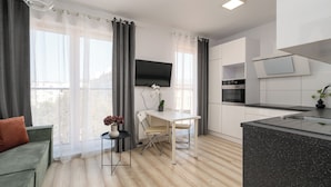 A modern apartment with a dining area, kitchen, and living space. - AS HOME Kościuszki 89 (Wrocław)