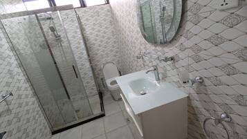 Shower, hair dryer, slippers, towels