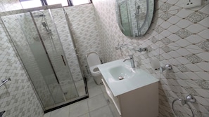 Shower, hair dryer, slippers, towels