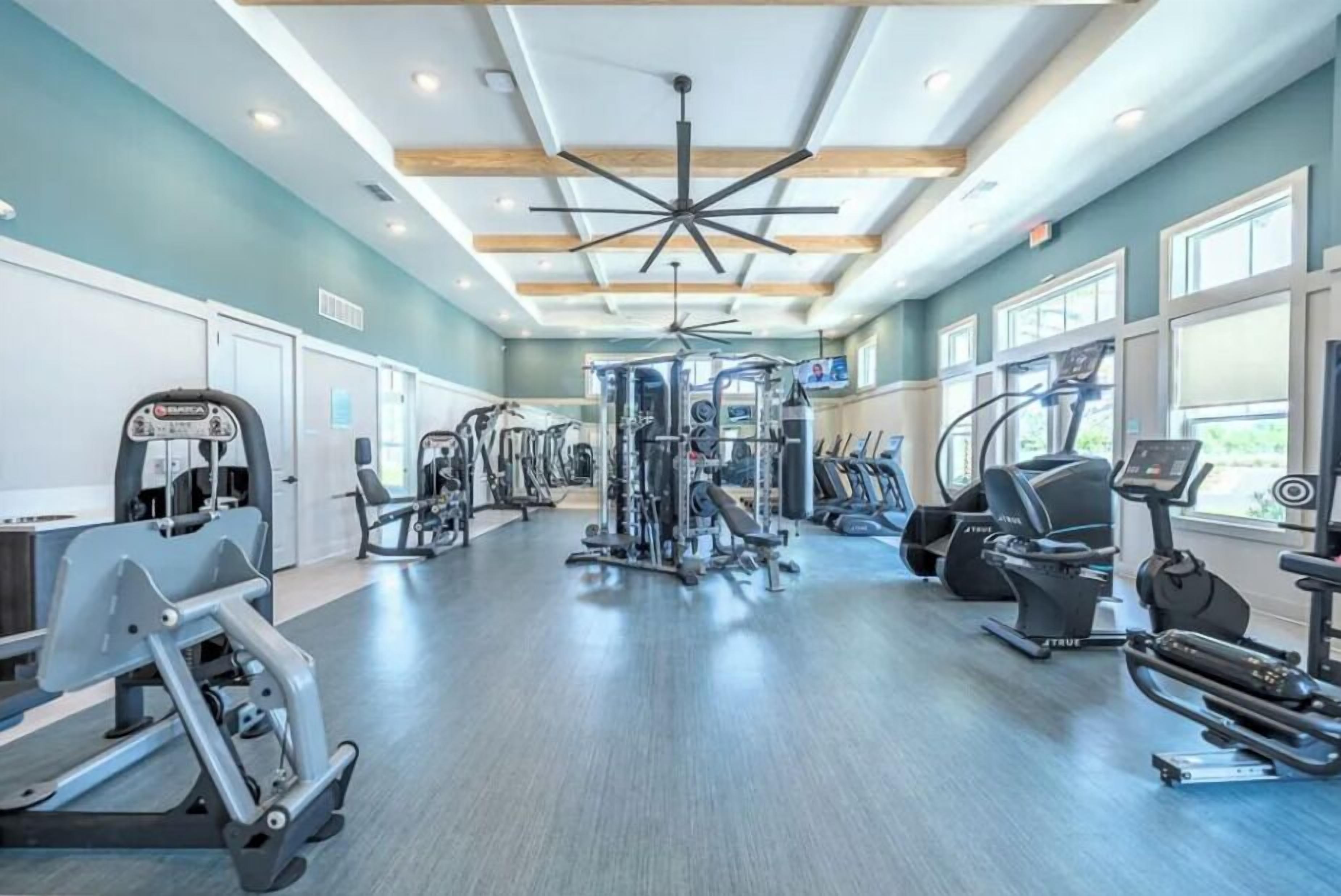 A gym with various exercise equipment, including treadmills and weight machines.