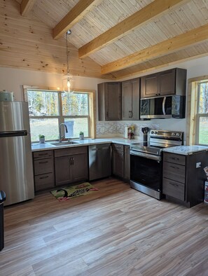Microwave, oven, stovetop, dishwasher - Charming 2-bedroom cabin with Water Views on Thayer Lake (Bellaire)