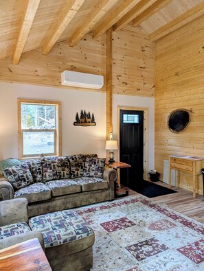 TV, fireplace - Charming 2-bedroom cabin with Water Views on Thayer Lake (Bellaire)