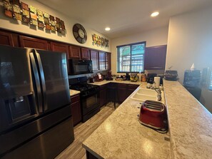 Fridge, microwave, oven, stovetop - This house is a 3 bedroom(s), 2.5 bathrooms, located in Santa Fe, NM. (Santa Fe)