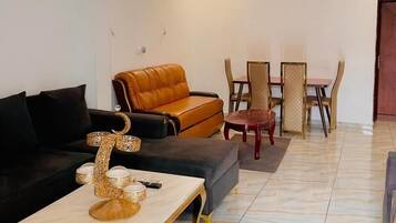 Deluxe Penthouse, Balcony, City View | Living area | Computer monitors