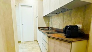 A compact kitchen with a built-in stove, a sink, and a coffee maker on the countertop. - La Palmetta (Near Metro A) (Roma)