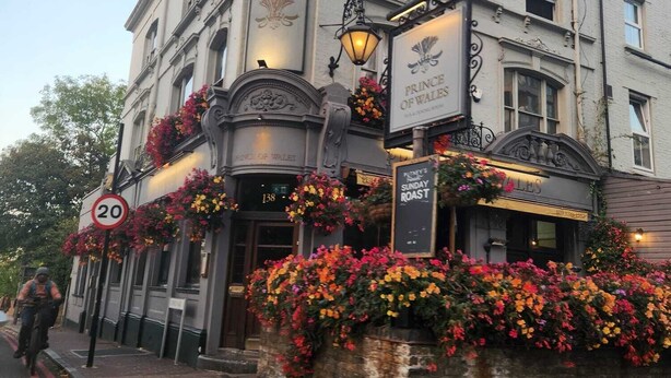 A building with a sign reading "Prince of Wales" and a "Sunday Roast" sign.