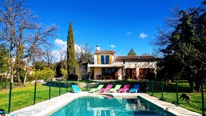 A swimming pool with lounge chairs, a fenced yard, and a house with a tiled roof in the background. - Quiet - Charming - Atypical - View Luberon - Parc Naturel du Luberon - GR97 (Saint-Saturnin-Lès-Apt)