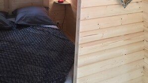 A cozy room with a bed, a nightstand with a lamp, and a heart-shaped wall decoration. - Barrel Orange Apartment with Mountain View, Private Terrace & Air Conditioning (Saint André)