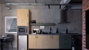 A modern kitchen with a microwave, refrigerator, sink, and washing machine. - C LIVING 3 - ALMALQA (Riyadh)