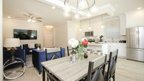 A modern kitchen with white cabinets, stainless steel appliances, and pendant lighting. - Fabulous 2-bedroom in a Prime location, Houston Medical center and NRG stadium! (Houston)