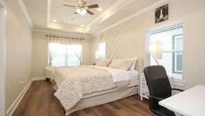 A bedroom with a bed, a desk, a chair, a ceiling fan, and a window with blinds. - Fabulous 2-bedroom in a Prime location, Houston Medical center and NRG stadium! (Houston)