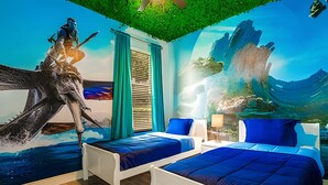 A room with two beds, a large mural of a sea creature, and a green ceiling.
